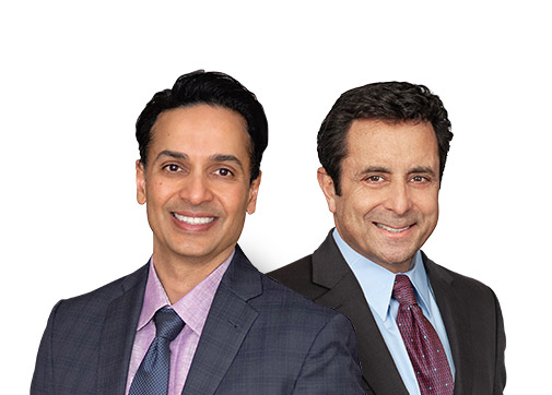 Dr. Shah and Wasserman smiling in suits